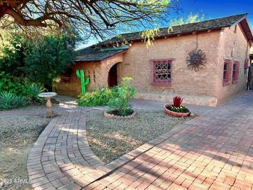 Brick pathway leads to charming adobe home with unique landscaping at 1924 E Monte Vista Rd, Phoenix, AZ 85006