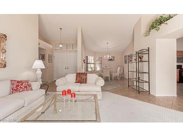 Bright living room with comfy seating and a view to the dining area at 19511 N 143Rd Dr, Sun City West, AZ 85375