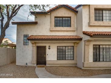 Two-story stucco townhouse with a Spanish-style tile roof and a private entrance at 2955 N Oregon St # 9, Chandler, AZ 85225