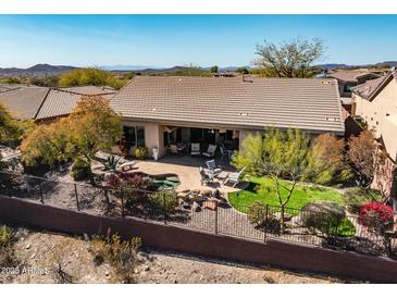 Inviting backyard with desert landscaping, small pool, and patio seating area at 41515 N Laurel Valley Way, Anthem, AZ 85086