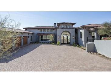 Stunning home exterior with red brick circular driveway and tile roof at 6825 N 39Th Pl, Paradise Valley, AZ 85253
