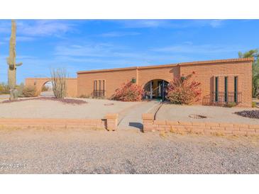 Brick ranch house with landscaped yard and a walkway at 888 W Vah Ki Inn Rd, Coolidge, AZ 85128