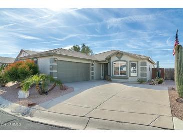 Single-story home with a two-car garage and desert landscaping at 8957 E Rainier Dr, Gold Canyon, AZ 85118