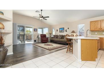 Open living space with hardwood floors, patio access, and a kitchen island at 8957 E Rainier Dr, Gold Canyon, AZ 85118