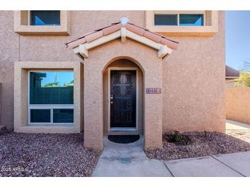 Inviting condo entry with decorative door and stone accents at 10445 N 11Th Pl # 1, Phoenix, AZ 85020