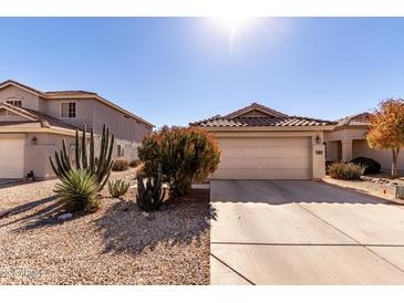 House exterior featuring a two-car garage and desert landscaping at 1151 E Stardust Way, San Tan Valley, AZ 85143