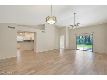 Bright and airy living room with tile floors and sliding glass doors at 1207 W Sea Bass Ct, Gilbert, AZ 85233