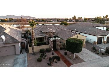 Luxury home with appealing landscaping, a golf course view, and a desirable location at 14335 W Monte Vista Rd, Goodyear, AZ 85395