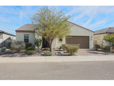 Single-story home with a two-car garage and desert landscaping at 16247 S 180Th Dr, Goodyear, AZ 85338