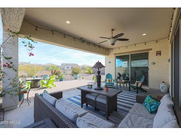 Covered patio with comfortable seating and string lights at 16247 S 180Th Dr, Goodyear, AZ 85338