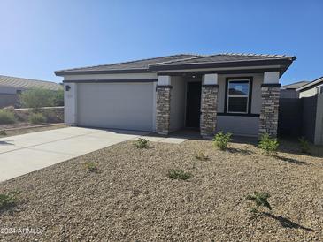 Single-story home with stone accents and a two-car garage at 18182 W Poston Dr, Surprise, AZ 85387