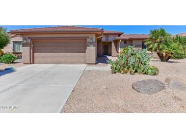 Single-story home with two-car garage and desert landscaping at 20876 N Canyon Whisper Dr, Surprise, AZ 85387