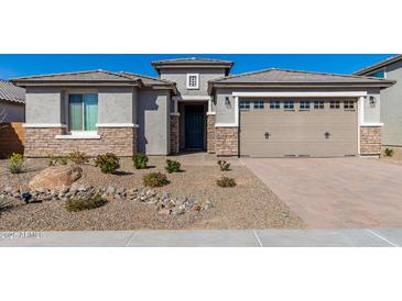 This home boasts desert landscaping and a two-car garage at 25948 W Sands Dr, Buckeye, AZ 85396