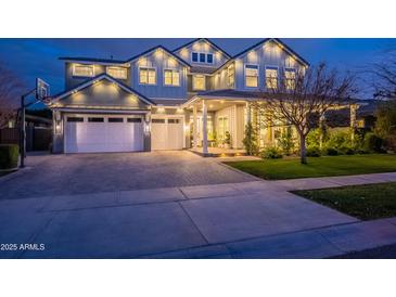 Stunning two-story home featuring a three-car garage, covered entry, and meticulous landscaping at 2967 E Boot Track Trl, Gilbert, AZ 85296