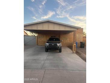 Newly constructed home with carport and front yard at 3133 W Polk St, Phoenix, AZ 85009