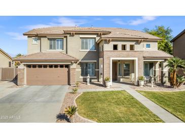 Stunning two-story home with a tile roof, manicured lawn, and a spacious two-car garage at 476 E Atlantic Dr, Casa Grande, AZ 85122