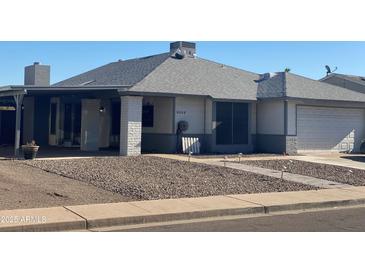 Single-story home with attached garage and landscaped front yard at 5312 W Columbine Dr, Glendale, AZ 85304