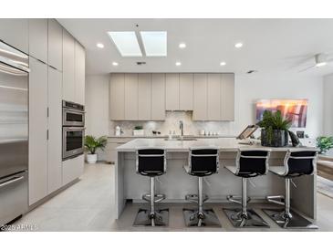 Modern kitchen featuring sleek cabinetry, a spacious island, and stainless steel appliances at 7705 E Doubletree Ranch Rd # 56, Scottsdale, AZ 85258