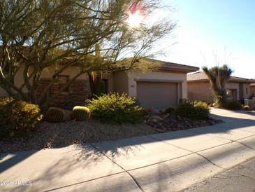 Single-story home with desert landscaping and two-car garage at 7741 E Balao Dr, Scottsdale, AZ 85266