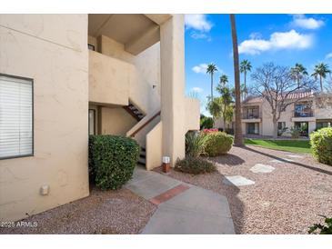 Exterior view of condo building with walkway and landscaping at 9275 E Mission Ln # 207, Scottsdale, AZ 85258