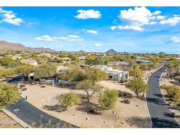 Aerial view of a luxurious home with a pool and landscaped grounds at 12129 N 114Th Way, Scottsdale, AZ 85259
