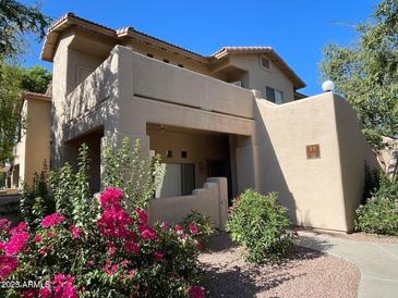 Tan two-story building with balcony and landscaping at 1351 N Pleasant Dr # 1102, Chandler, AZ 85225