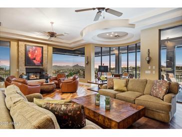 Spacious living room with hardwood floors, fireplace, and stunning mountain views at 15529 E Sycamore Dr, Fountain Hills, AZ 85268