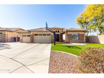 Charming single-story home featuring a three-car garage and a basketball hoop in the driveway at 20540 N 86Th Ln, Peoria, AZ 85382