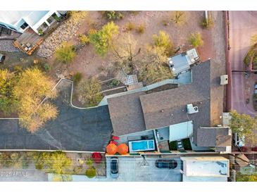 Aerial view of a property featuring a pool, landscaped yard, and unique architectural design at 2306 N 55Th St, Phoenix, AZ 85008
