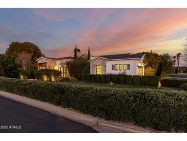 Brick house with a landscaped yard at dusk at 5430 E Calle Redonda --, Phoenix, AZ 85018