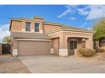 Two-story home featuring a two-car garage, covered porch, and neutral-toned stucco exterior at 15118 W Lincoln St St, Goodyear, AZ 85338