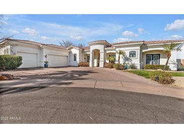 Stunning single-story home with a three car garage and well-manicured landscaping at 1560 W Augusta Ave, Phoenix, AZ 85021