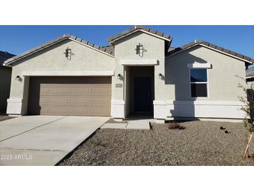 Charming single-story home featuring a two-car garage, a covered porch, and low-maintenance landscaping at 18864 E Bruno Dr, Gold Canyon, AZ 85118