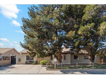 Ranch style home with mature trees and a spacious front yard at 3432 N 86Th Ave, Phoenix, AZ 85037