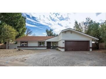 Single-story home with brown roof and a paved driveway at 356 Ancora W Dr, Litchfield Park, AZ 85340