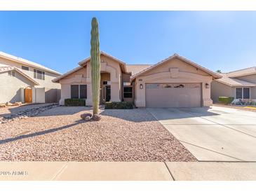 Single-story house with a two-car garage and desert landscaping at 4213 E Stanford Ave, Gilbert, AZ 85234