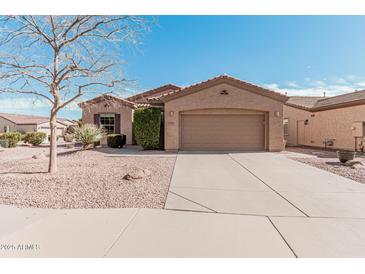 Single-story home with desert landscaping and two-car garage at 5077 S Barley Way, Gilbert, AZ 85298