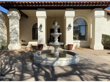 Inviting entryway with a beautiful fountain and well-manicured landscaping at 8028 E La Junta Rd, Scottsdale, AZ 85255