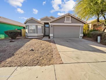 Gray house with a two-car garage and small front yard at 9023 W Hubbell St, Phoenix, AZ 85037