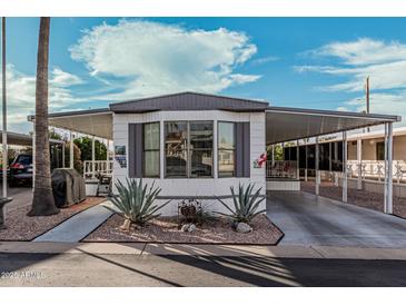 Single-wide manufactured home with carport and desert landscaping at 9333 E University Dr # 86, Mesa, AZ 85207