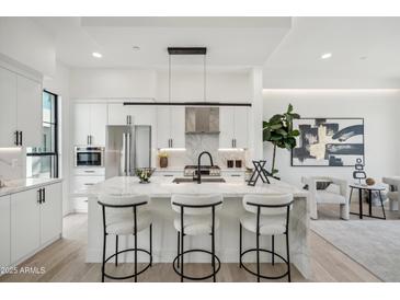 Modern kitchen with marble island, stainless steel appliances, and white cabinetry at 1501 N Miller Rd # 1003, Scottsdale, AZ 85257