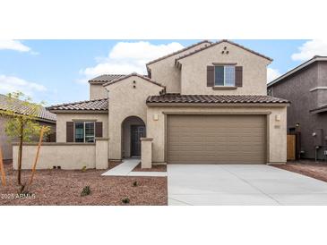 Charming two-story home featuring stucco siding, a tiled roof, and a two-car garage at 17857 W Getty Dr, Goodyear, AZ 85338