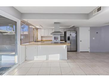 Bright kitchen with stainless steel appliances and an island at 225 N Standage St # 78, Mesa, AZ 85201