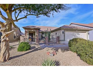 Single-story home with stone accents and landscaped front yard at 25746 W Hess Ave, Buckeye, AZ 85326