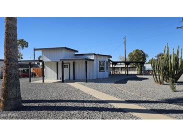 Modern home exterior with unique architectural details and gravel landscaping at 358 N 82Nd Way, Mesa, AZ 85207