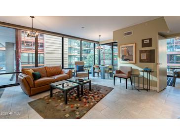 Open living area with leather sofa, large windows, and city views at 4808 N 24Th St # 305, Phoenix, AZ 85016