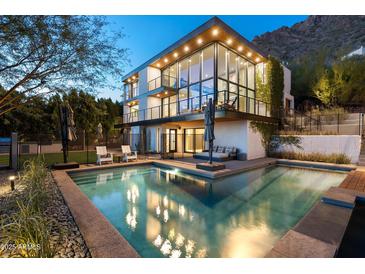 Luxury home with a stunning pool and mountain views at dusk at 5419 E Valle Vista Rd, Phoenix, AZ 85018