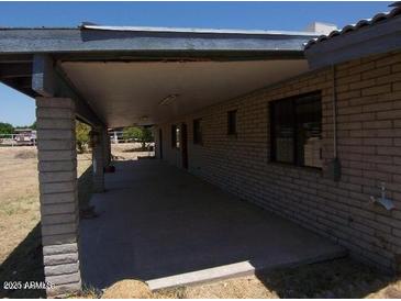 Spacious covered patio, ideal for outdoor entertaining, adjacent to the house at 7224 S 233Rd Dr, Buckeye, AZ 85326