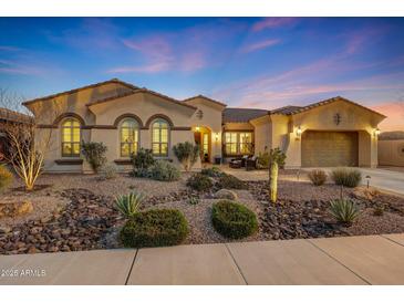 Beautiful single-story home with desert landscaping and a three-car garage at 18125 W Acacia Dr, Goodyear, AZ 85338
