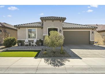 Charming home with a well-maintained front yard and a two-car garage at 27395 W Wahalla Ln, Buckeye, AZ 85396